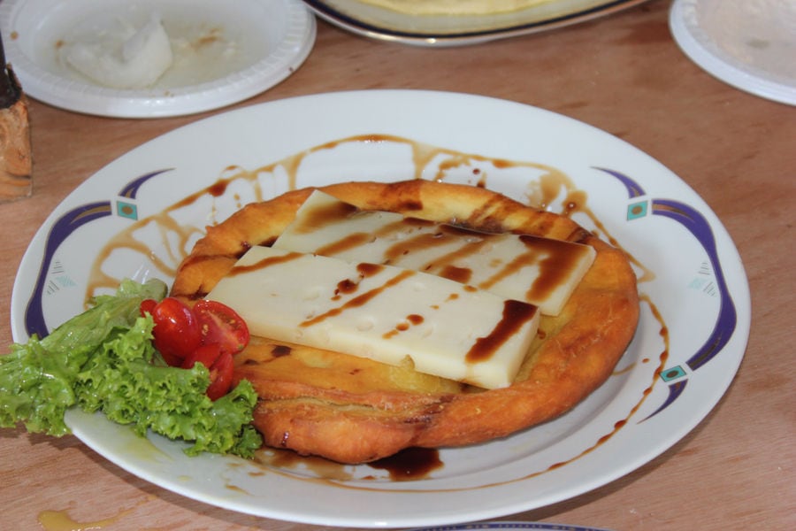 plate with fried pie and cheese on top with petimezi at 'Wisdom of Nature'